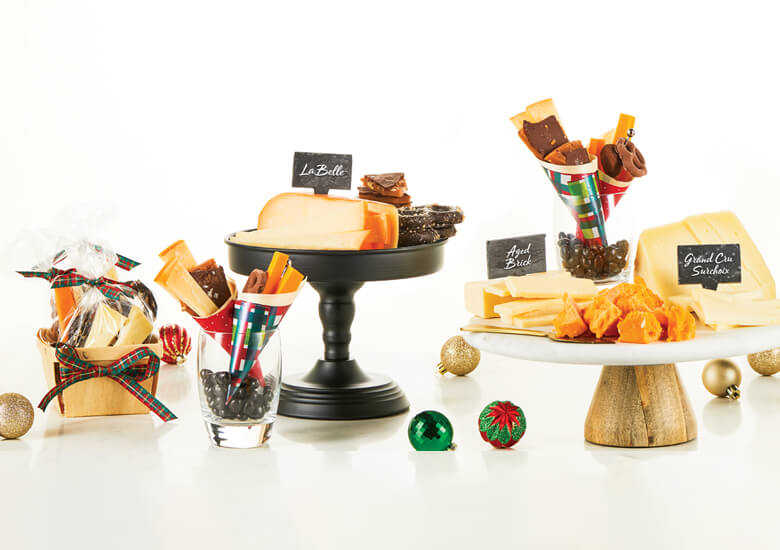 Holiday cheeses on black display stands