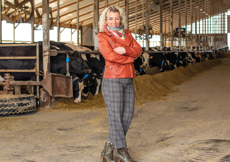 Marieke Penterman in barn with cows